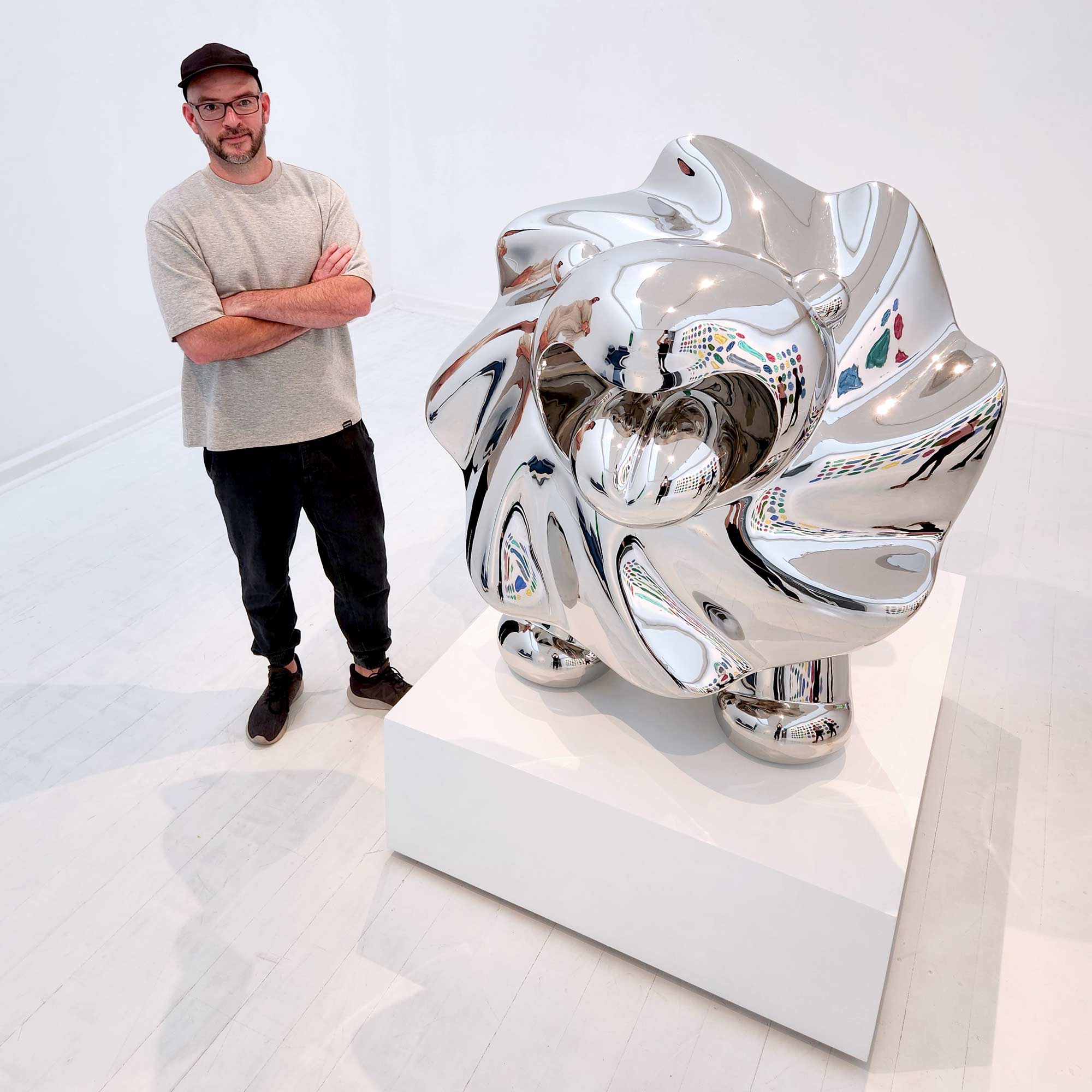 Lions breath stainless steel sculpture with Ferdi B Dick the artist standing next to sculpture 