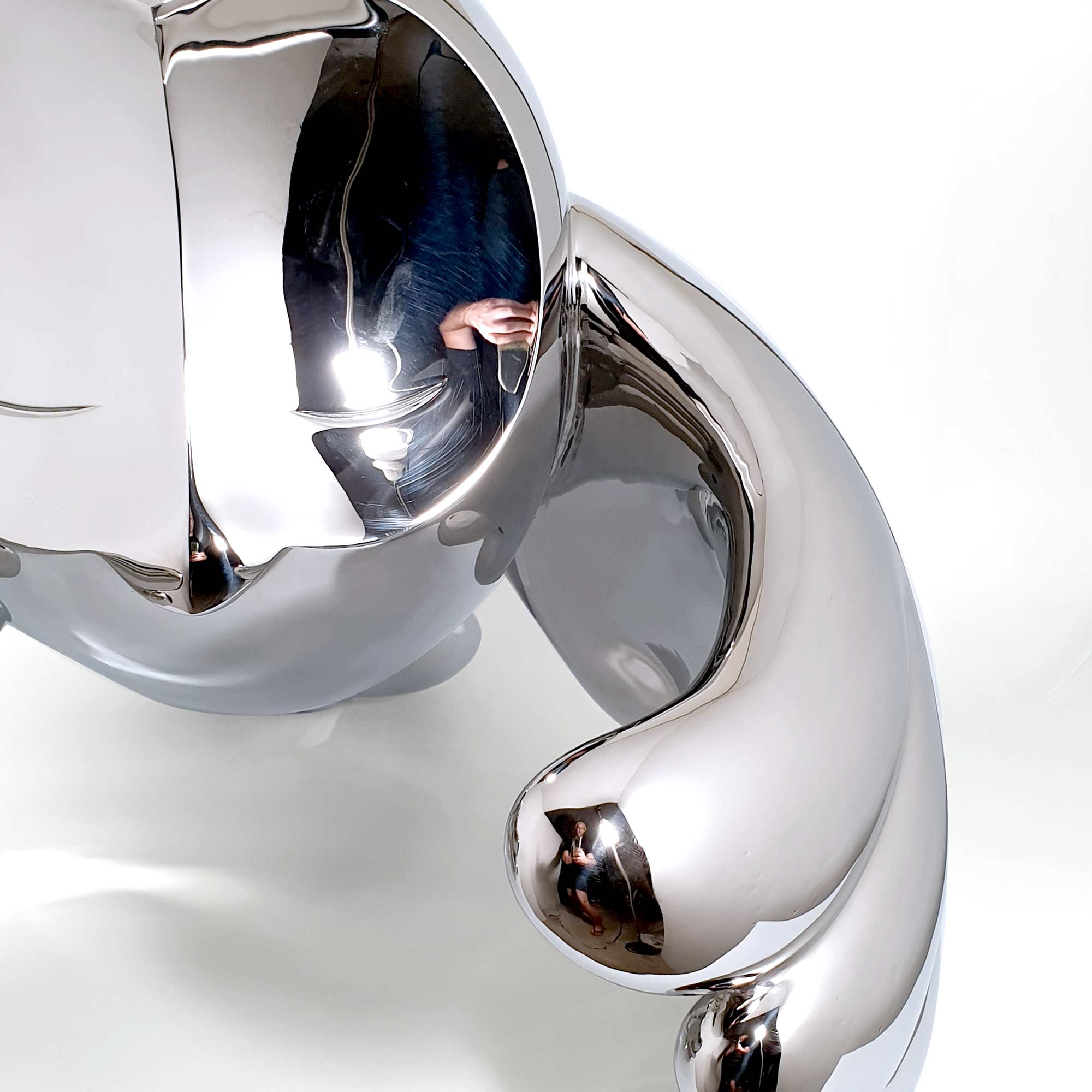 Wind Beneath Owl, bird sculpture, Mirror Polished Stainless Steel Sculpture, by artist Ferdi B Dick, close up